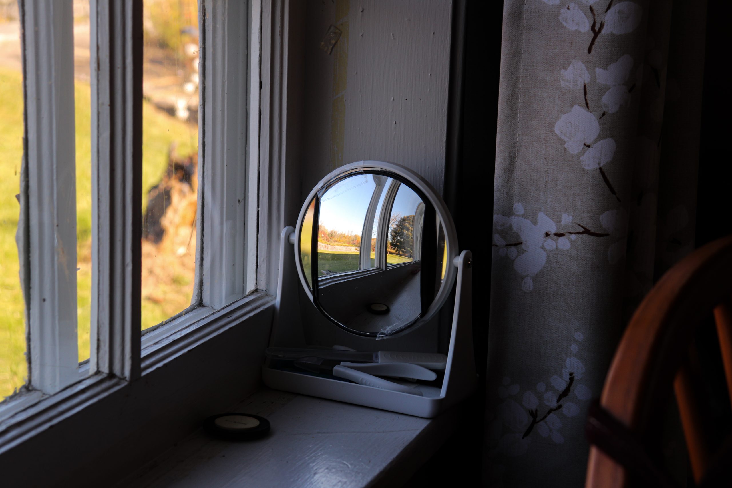 A small mirror rests on the windowsill of Allyn Hess Perry's private residence, located in the Old Canal Store building along the towpath of the original Erie Canal, built in 1825. Allyn cleverly positioned the mirror to reflect the passing boats and kayakers, allowing her to enjoy the scenic activity from her La-Z-Boy in the living room.