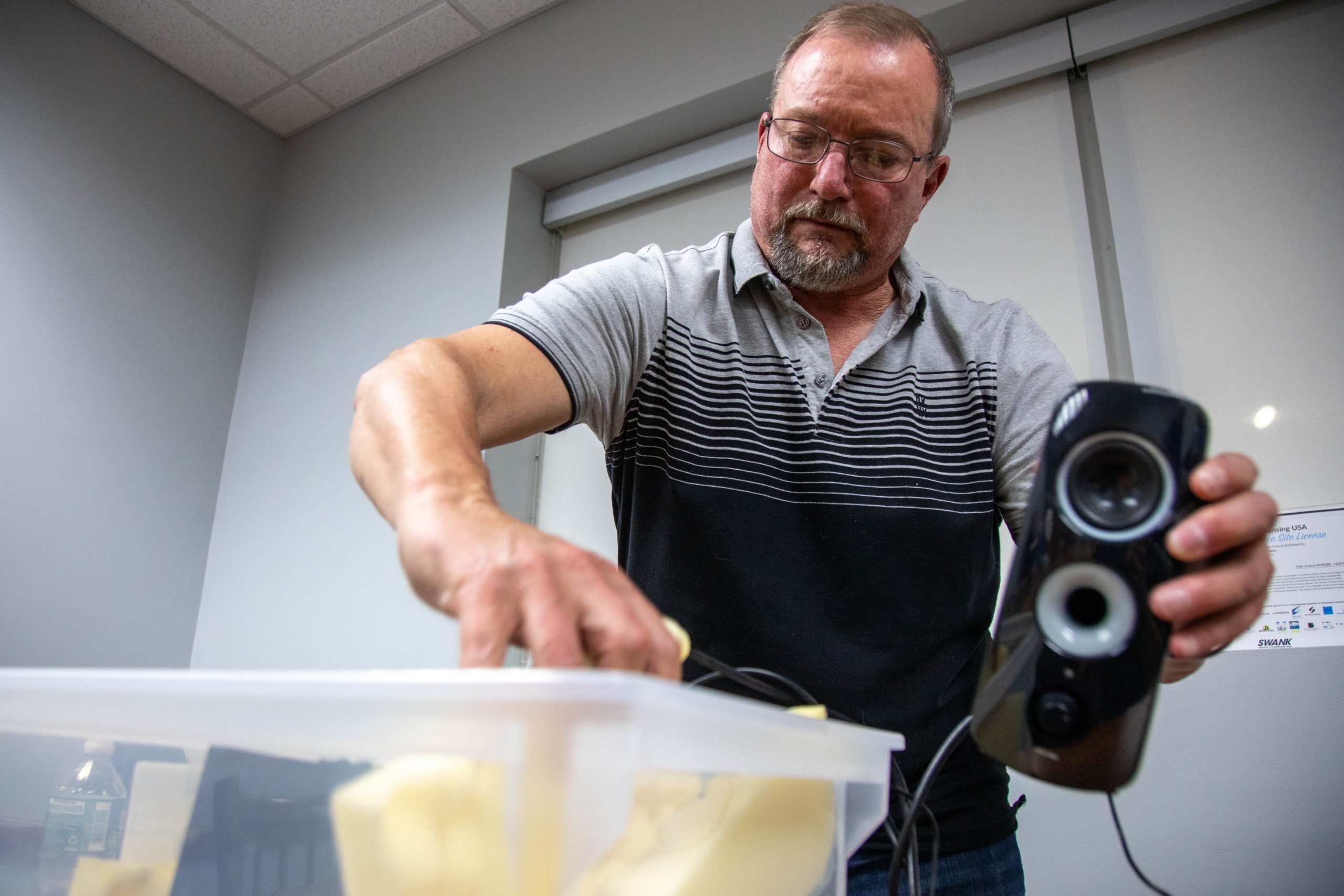 Steve Kinne packs his audio equipment at the Manlius Public Library on March 19.
