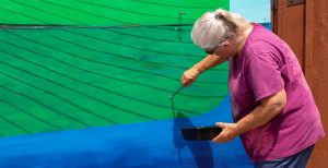 Artist Beverly Owen painting the latest mural from the Mural Mania art mission at the Liz and Dave Beebe Camillus Erie Canal Park in Onondaga County on Thursday, June 20.