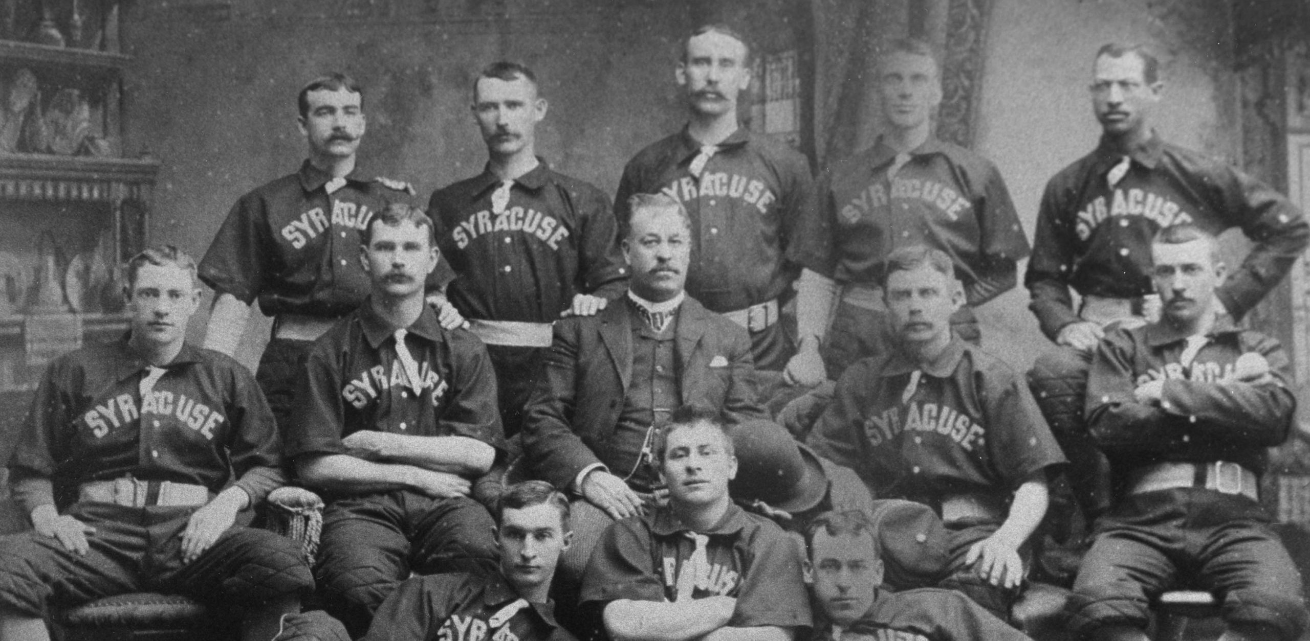 The Syracuse Stars Base Ball Club poses for a team portrait in 1889. Negro baseball pioneer Moses Fleetwood Walker is in the back row, far right.