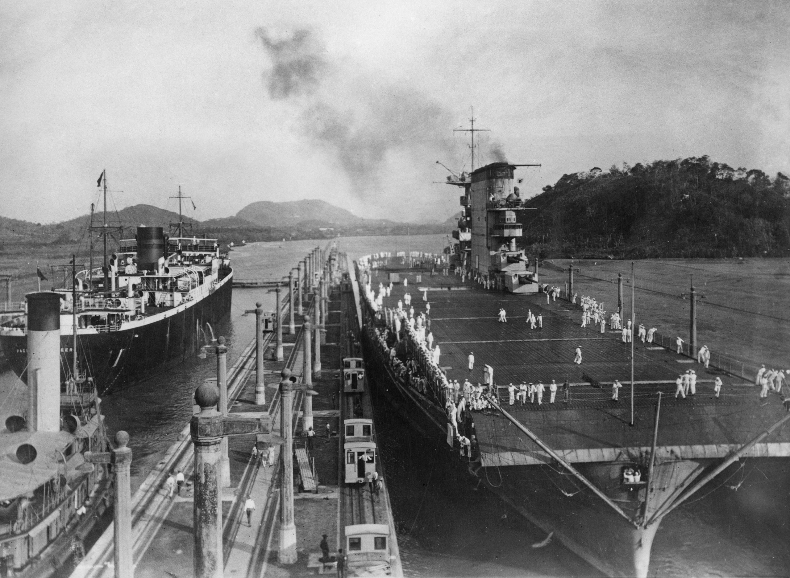 US Navy crew on the deck of the aircraft carrier USS Lexington (CV-2) in the Miraflores Locks on the Panama Canal, in Panama, circa 1930. Nicknamed 'Lady Lex', USS Lexington is en route to the Pacific Ocean to join her sister ship, USS Saratoga. (Photo by Henry Miller News Picture Service/FPG/Hulton Archive/Getty Images)