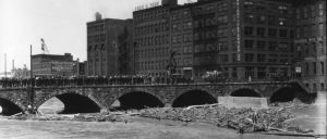 View of the Andrew's St. Bridge, looking east, during a flood in Rochester, NY on July 26, 1920. Photo by New York (State). Department of Public Works